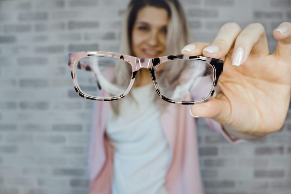 A female employee holds a pair of eyeglasses