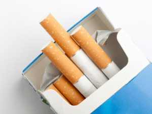 Open pack of cigarettes showing several cigarettes inside.