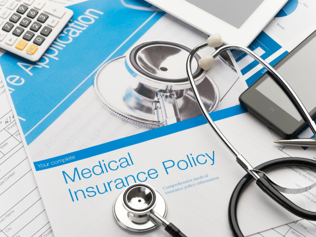 Medical insurance policy with stethoscope and digital devices.