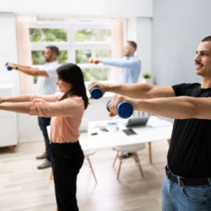 A group of employees lift weights in their wellness program