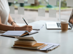 A person taking notes at a desk. 