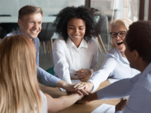 Diverse group of professionals stacking hands in a display of teamwork and unity.