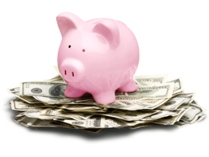 Pink piggy bank sitting on a pile of dollar bills, representing savings or financial management.